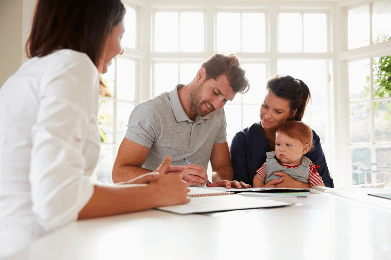 Family signing mortgage paperwork