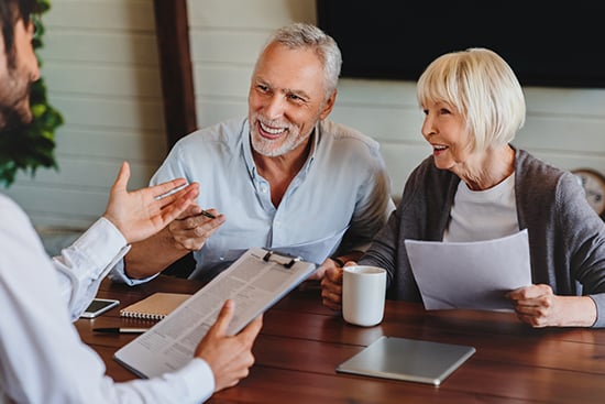 Senior couple speaking with loan officer